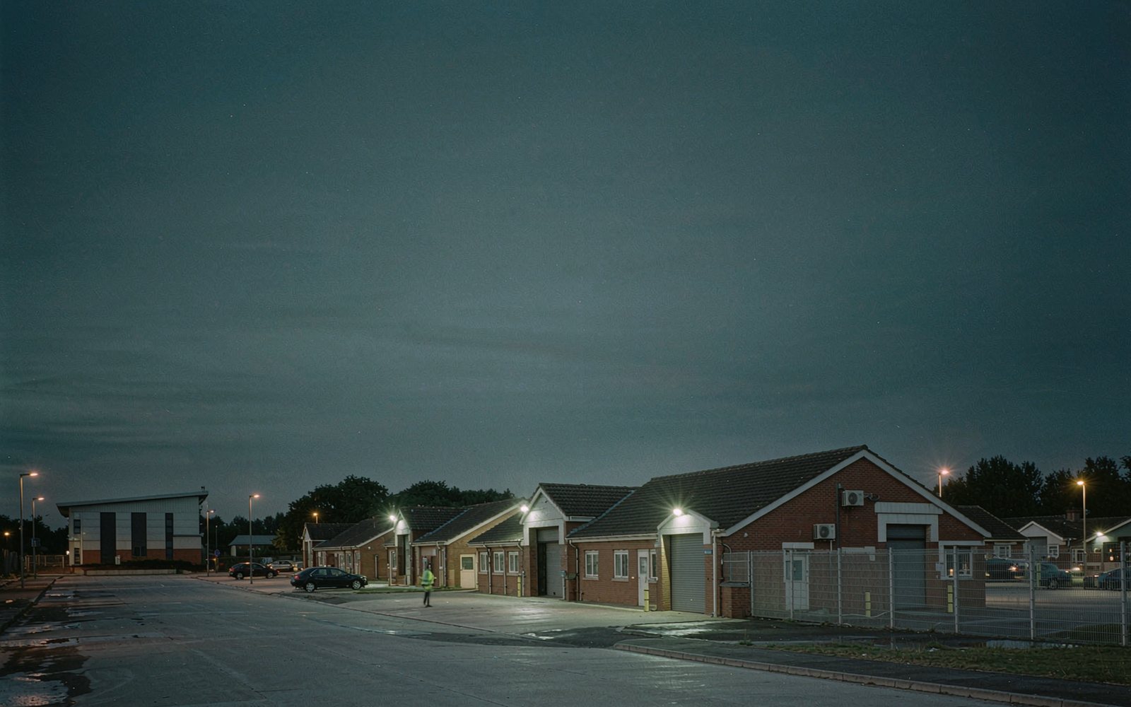 Commercial and industrial park at dusk with an officer on the service road