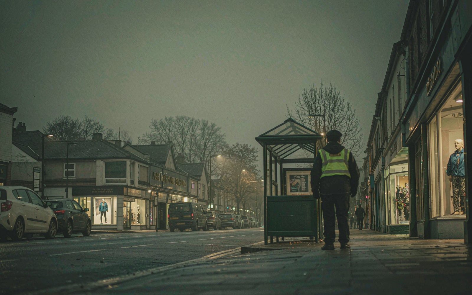 Town high street in the early evening with an officer on patrol