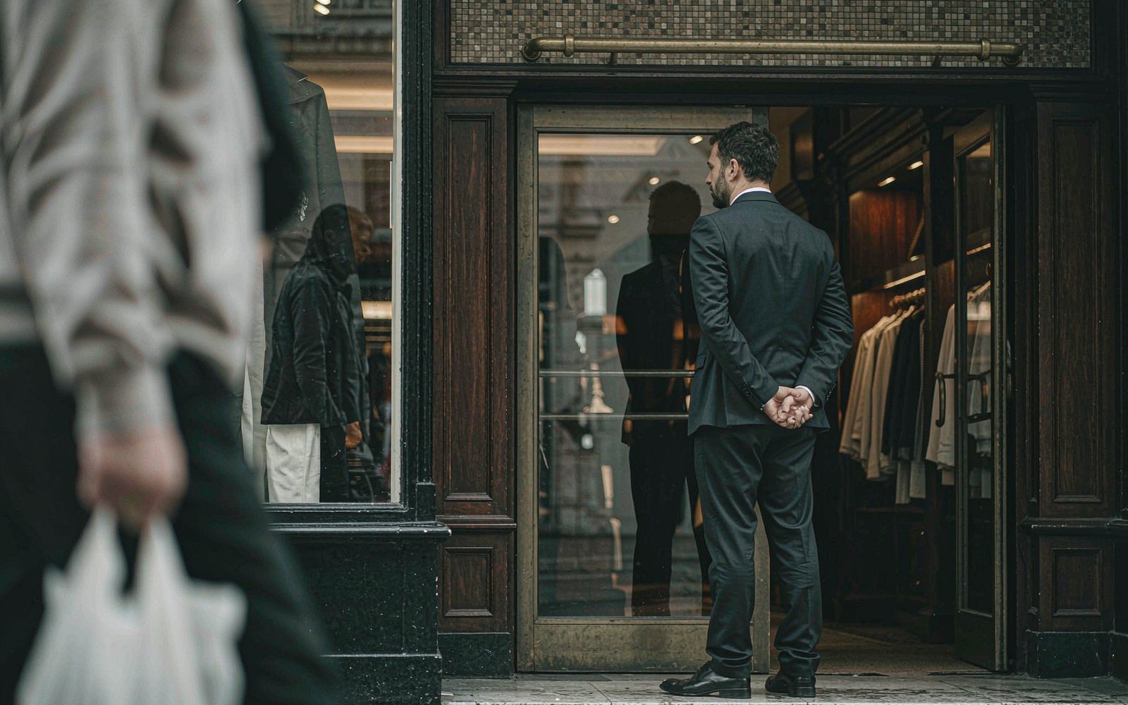 Retail officer watching the store frontage from inside the entrance