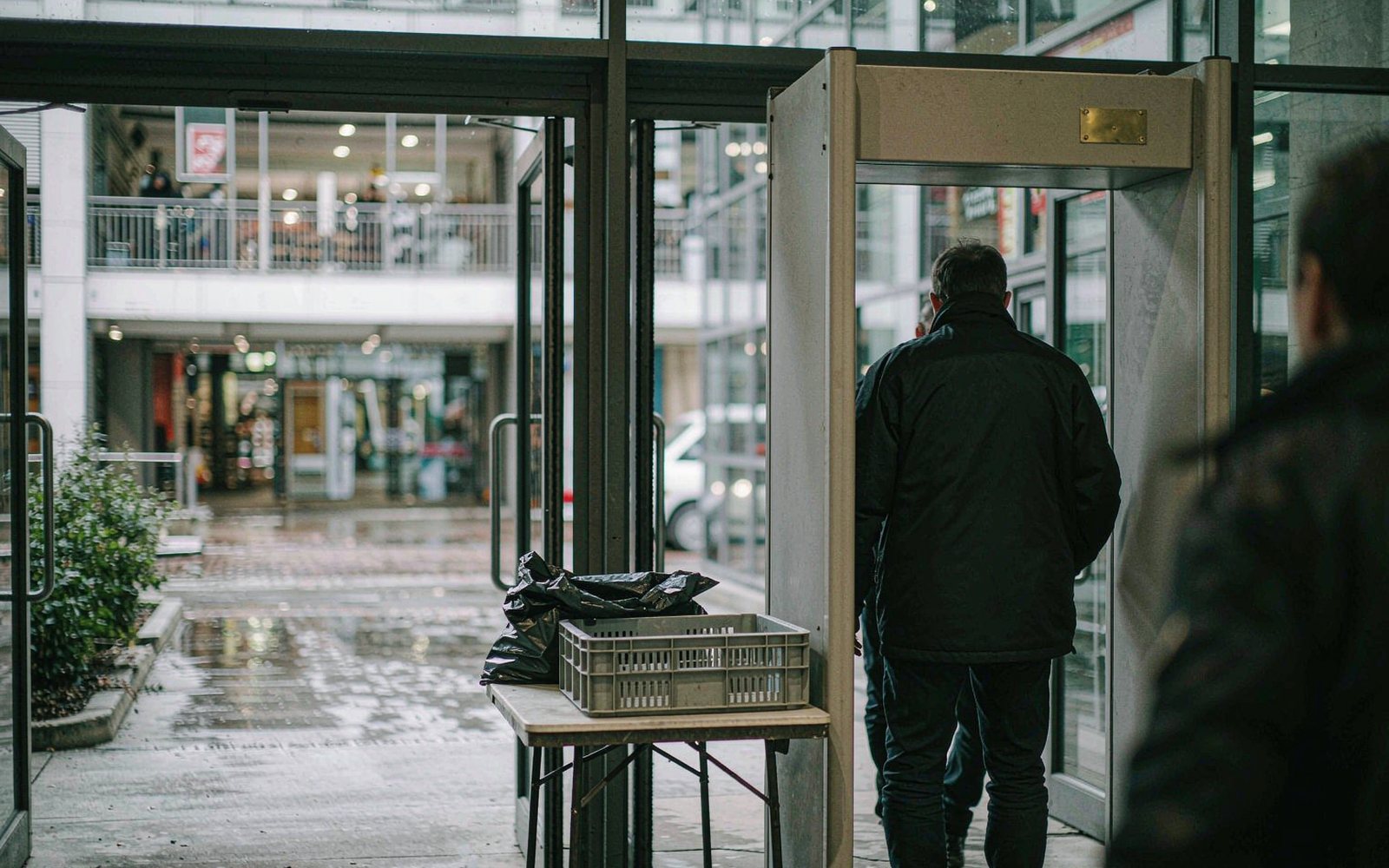 Entrance screening with a tray table and walk-through detector