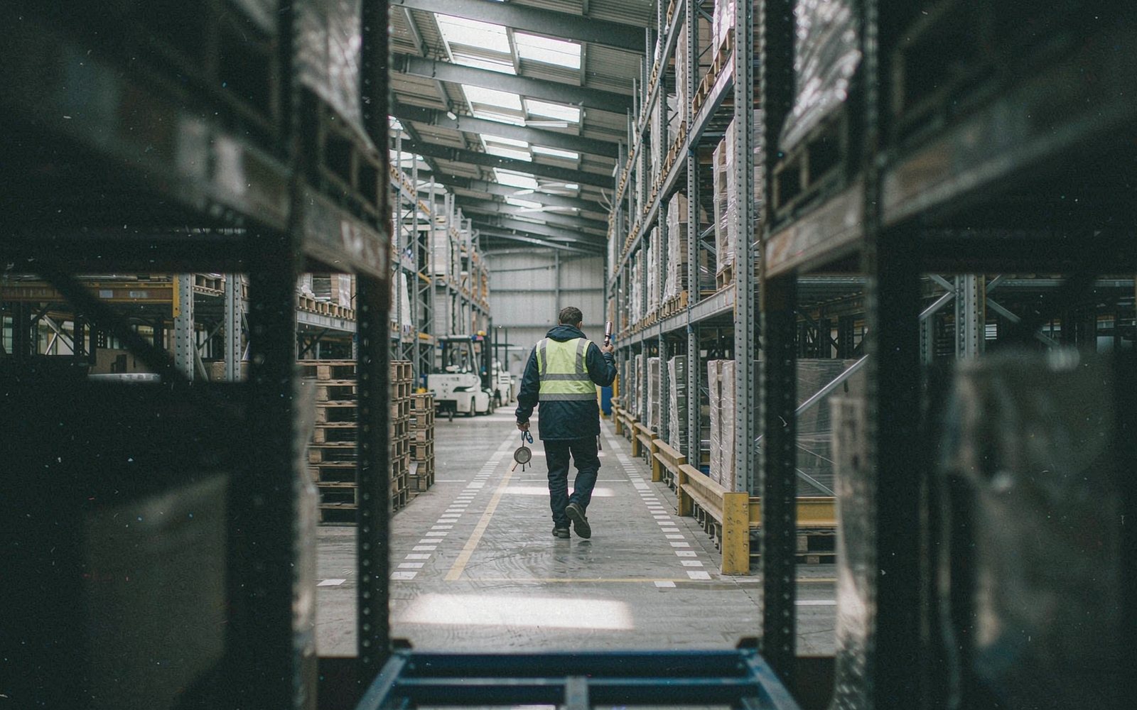 Patrol of a warehouse aisle between pallet racking
